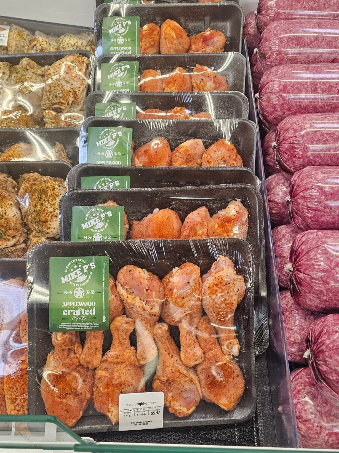 A grocery meat case featuring products seasoned with Mike P's