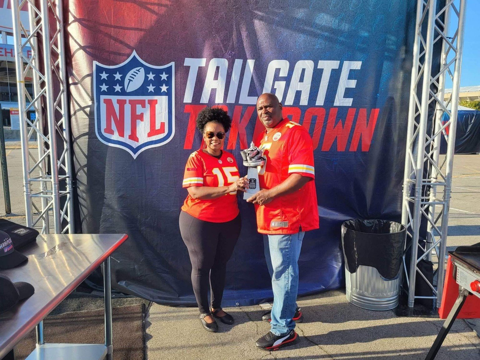 Mike P holding the NFL Tailgate Takedown trophy